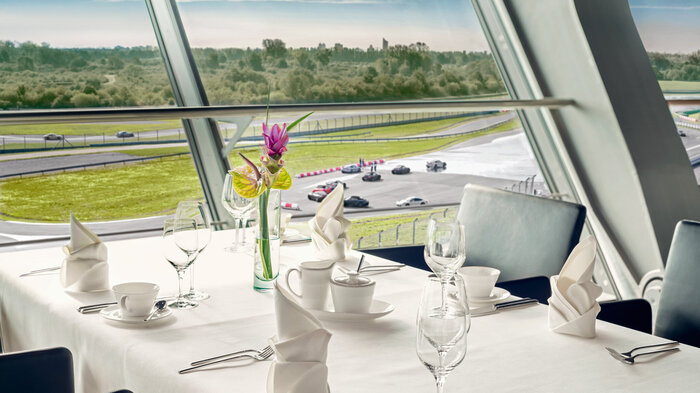 elegantly set table with a view of the circuit