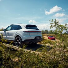 Ein Porsche Cayenne im Gelände bei der Überfahrt über eine Brücke