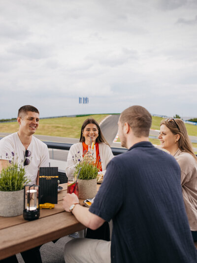Kollegen trinken zusammen auf der Terasse des Carrera Cafes Getränke.